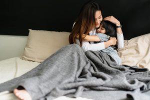 mom hugging daughter